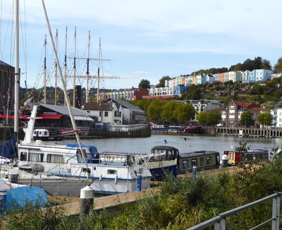 Painted houses stacked on the hillside above Bristol harbour