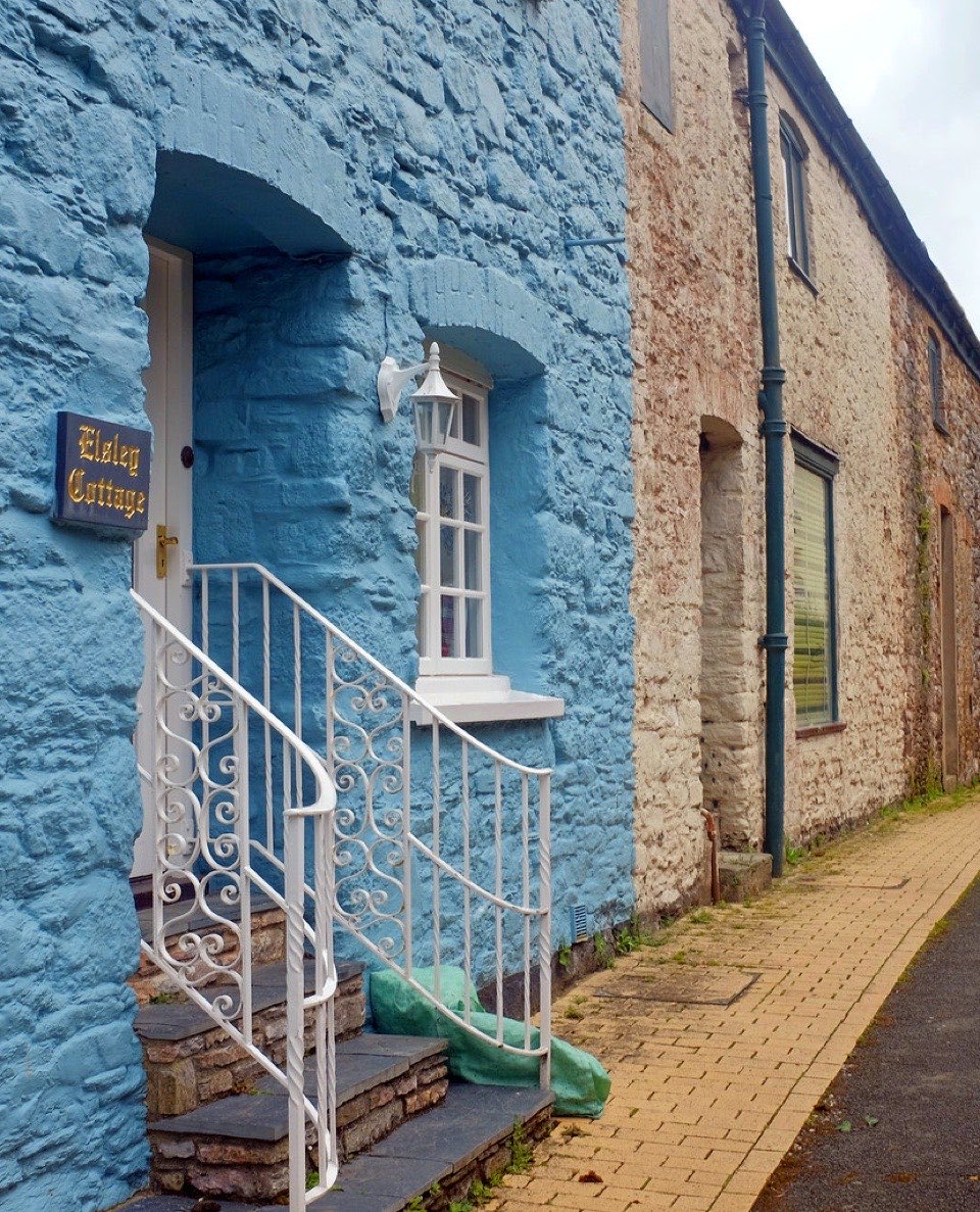 A blue painted stone house on a hill at Dartmouth in South Devon