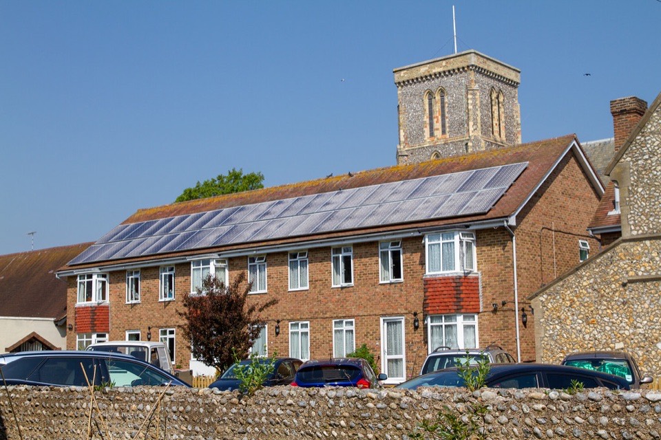 Solar panels covering the pitched roof of a brick terrace in England